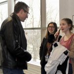 Students testing out an ear trumpet