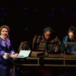 Three female astronomers sitting at a table