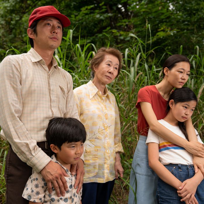 A family of Korean Americans standing among tall grass